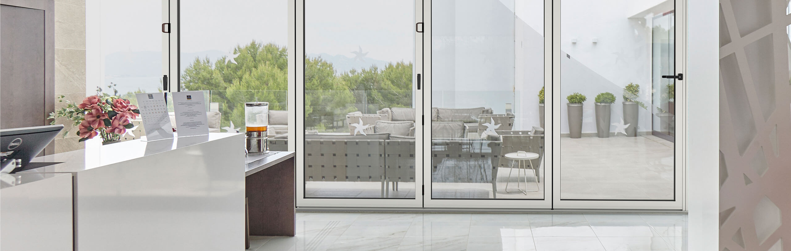Cortizo aluminium bi-fold doors opening onto a garden